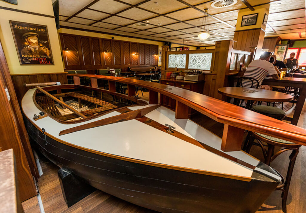Boat installation used as a feature element inside The Galway Hooker Irish Pub in Scarborough, Western Australia, integrated into the seating and circulation area.